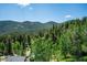 Panoramic view showcasing lush greenery and majestic mountains for serene scenery at 32392 Lodgepole Dr, Evergreen, CO 80439