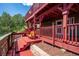 Inviting outdoor deck featuring a charming swing, perfect for relaxing and enjoying the scenic views at 32392 Lodgepole Dr, Evergreen, CO 80439