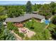 Aerial view of a home with a patio, fire pit, basketball court and large green backyard at 3980 S Dexter St, Cherry Hills Village, CO 80113