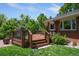 Back deck and grassy backyard view with grill, stairs, and partial home exterior at 3980 S Dexter St, Cherry Hills Village, CO 80113