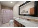 Cozy bathroom features a granite countertop vanity and a shower with patterned curtain at 3980 S Dexter St, Cherry Hills Village, CO 80113