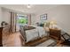 Comfortable bedroom featuring hardwood floors, large window, and classic furnishings at 3980 S Dexter St, Cherry Hills Village, CO 80113
