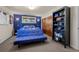 Bedroom with futon, blue accent wall, closet, and carpeting at 3980 S Dexter St, Cherry Hills Village, CO 80113