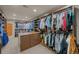 Spacious walk-in closet with custom shelving and ample storage space, including central storage island at 3980 S Dexter St, Cherry Hills Village, CO 80113