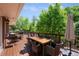 Entertain on this wooden deck with outdoor dining and lounging areas overlooking the backyard at 3980 S Dexter St, Cherry Hills Village, CO 80113