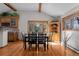 Dining room features a large wooden table, hardwood floors, and bright windows at 3980 S Dexter St, Cherry Hills Village, CO 80113