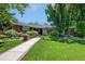 Well-manicured lawn and mature landscaping leading to the home's front entrance with a brick mailbox at 3980 S Dexter St, Cherry Hills Village, CO 80113