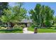 Charming single-story home featuring a brick exterior, lush landscaping, and a welcoming walkway at 3980 S Dexter St, Cherry Hills Village, CO 80113