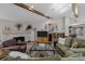 Open-concept living room with a stone fireplace and hardwood floors at 3980 S Dexter St, Cherry Hills Village, CO 80113