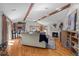 Open living room with vaulted ceilings, a stone fireplace, and hardwood floors at 3980 S Dexter St, Cherry Hills Village, CO 80113