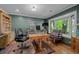 Home office with custom built-ins, a large bay window, and hardwood floors at 3980 S Dexter St, Cherry Hills Village, CO 80113