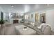 Spacious basement with a large sectional sofa, an ottoman, and stairs leading to another level at 3488 Dawson Rd, Sedalia, CO 80135