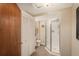 Bright bathroom features a glass shower, toilet, and white bi-fold doors, all atop tile floors at 3488 Dawson Rd, Sedalia, CO 80135