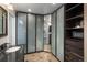 Bathroom with a granite sink, frosted glass doors, and a closet with shelves and drawers at 3488 Dawson Rd, Sedalia, CO 80135
