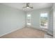 Bedroom with plush carpet, two windows, and light teal walls, creating a serene and inviting space at 3488 Dawson Rd, Sedalia, CO 80135