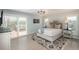 Bright bedroom features light wood floors, a ceiling fan, a sliding glass door, and a walk-out deck at 3488 Dawson Rd, Sedalia, CO 80135