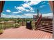 Multi-level wooden deck with seating area, grill, and lush, scenic views in the background at 3488 Dawson Rd, Sedalia, CO 80135