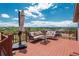 Spacious deck offers mountain views, outdoor seating, and an umbrella for shade on sunny days at 3488 Dawson Rd, Sedalia, CO 80135