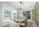 Bright dining room featuring a round table, stylish chairs, decorative wallpaper, and sliding glass doors leading to the patio at 3488 Dawson Rd, Sedalia, CO 80135