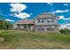 Charming two-story home featuring a well-maintained lawn, brick accents, and flower boxes under the windows at 3488 Dawson Rd, Sedalia, CO 80135