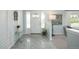 Bright foyer with tiled flooring, shiplap, and decorative plant, enhanced by natural light streaming through sidelight windows at 3488 Dawson Rd, Sedalia, CO 80135