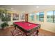 Game room with pool table and large windows overlooking the surrounding landscape at 3488 Dawson Rd, Sedalia, CO 80135