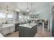 Light-filled kitchen includes granite counters, island, stainless appliances, and a built-in window seat at 3488 Dawson Rd, Sedalia, CO 80135