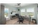 Office space featuring a wooden desk, chair, and shelving unit with large windows and natural lighting at 3488 Dawson Rd, Sedalia, CO 80135