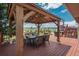 Relaxing covered patio with a dining table offering scenic mountain views at 3488 Dawson Rd, Sedalia, CO 80135