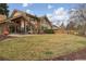 Large backyard featuring mature trees, a well-maintained lawn, and an outdoor patio area at 5149 E Links Cir, Centennial, CO 80122