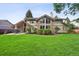 Landscaped backyard showcasing lush green lawn and a covered patio at 5149 E Links Cir, Centennial, CO 80122