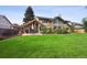A spacious backyard features a large lawn and patio seating area at 5149 E Links Cir, Centennial, CO 80122