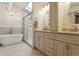 Elegant bathroom features a soaking tub, glass-enclosed shower, and marble-topped vanity at 5149 E Links Cir, Centennial, CO 80122