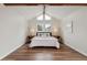 Bright bedroom features vaulted ceilings, exposed wood beams, and a light color palette at 5149 E Links Cir, Centennial, CO 80122