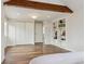 Cozy bedroom with hardwood floors, exposed beam, built-in bookshelves, and ample closet space at 5149 E Links Cir, Centennial, CO 80122