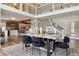 Dining room is located adjacent to a modern kitchen with wood floors and views of the upper level at 5149 E Links Cir, Centennial, CO 80122