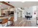 Open-concept dining area with wood floors and modern lighting is adjacent to kitchen at 5149 E Links Cir, Centennial, CO 80122