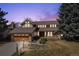 Inviting two-story home with manicured lawn and mature trees, highlighted by a beautiful dusk sky at 5149 E Links Cir, Centennial, CO 80122