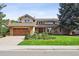 Charming two-story home featuring a well-maintained lawn and a spacious two-car garage at 5149 E Links Cir, Centennial, CO 80122