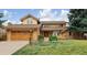 Charming two-story home boasts a well-manicured lawn, mature trees, and attached two car garage at 5149 E Links Cir, Centennial, CO 80122
