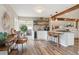 Modern kitchen features wood floors, a bar area, an island, and updated appliances at 5149 E Links Cir, Centennial, CO 80122
