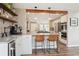 Modern kitchen with white cabinets, open shelves, and an eat-in island perfect for entertaining at 5149 E Links Cir, Centennial, CO 80122