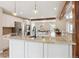 Open-concept kitchen with granite countertops, an island and stainless steel appliances at 5149 E Links Cir, Centennial, CO 80122
