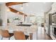 Spacious kitchen with barstool seating, stainless steel appliances, and light wood flooring at 5149 E Links Cir, Centennial, CO 80122