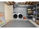 Functional laundry room with a side-by-side washer and dryer, and storage shelves at 5149 E Links Cir, Centennial, CO 80122