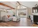 Cozy living room with vaulted ceilings, wood floors, and a sliding door to the backyard at 5149 E Links Cir, Centennial, CO 80122