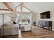 Cozy living room with vaulted ceilings, wood floors, and a sliding door to the backyard at 5149 E Links Cir, Centennial, CO 80122