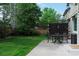 Large backyard with privacy fence offers a patio with dining set, ideal for outdoor living and entertaining at 9882 S Hoyt Ct, Littleton, CO 80127