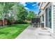Spacious backyard features a concrete patio ideal for outdoor dining and relaxing, complemented by a lush lawn at 9882 S Hoyt Ct, Littleton, CO 80127