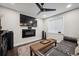 Basement living area with a mounted TV and a linear fireplace at 9882 S Hoyt Ct, Littleton, CO 80127